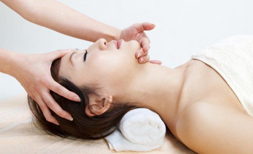 lady on massage table treatment for migraine