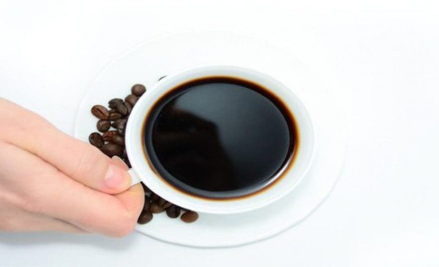 blog picture of hand grabbing a cup of coffee