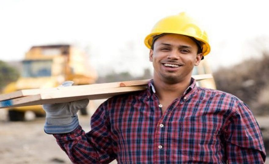 blog picture of construction worker carrying lumber