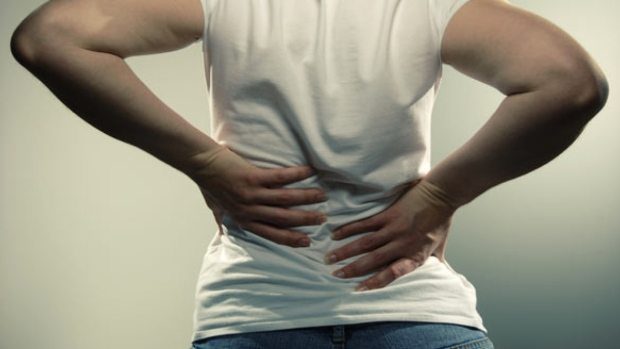 blog picture of a man grabbing his back in pain
