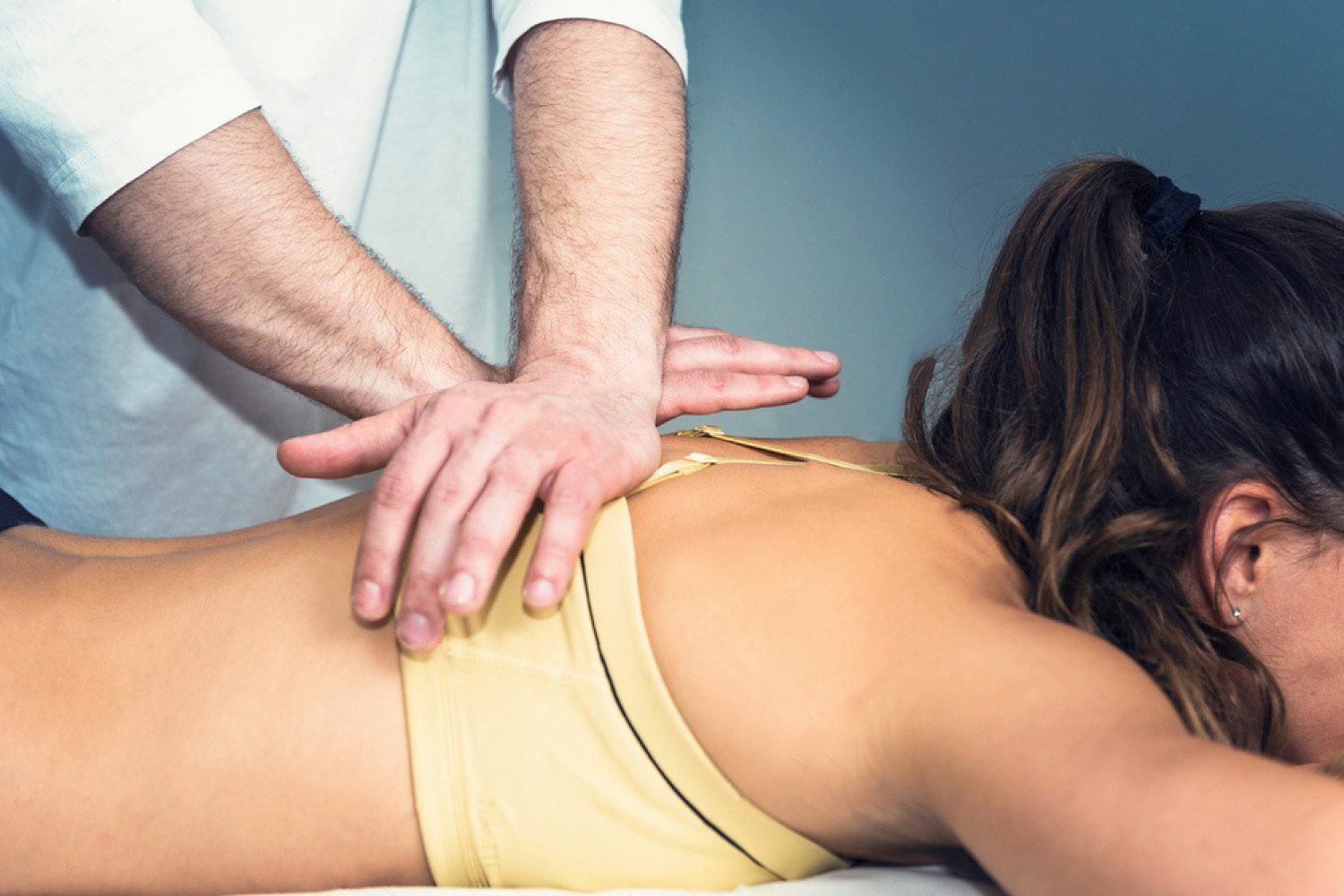 chiropractor doing a spinal adjustment on lady