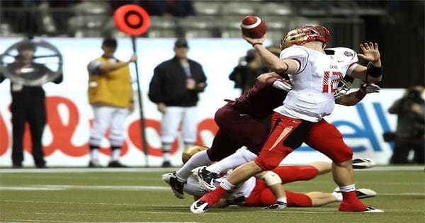 blog picture of football quarterback getting hit from behind