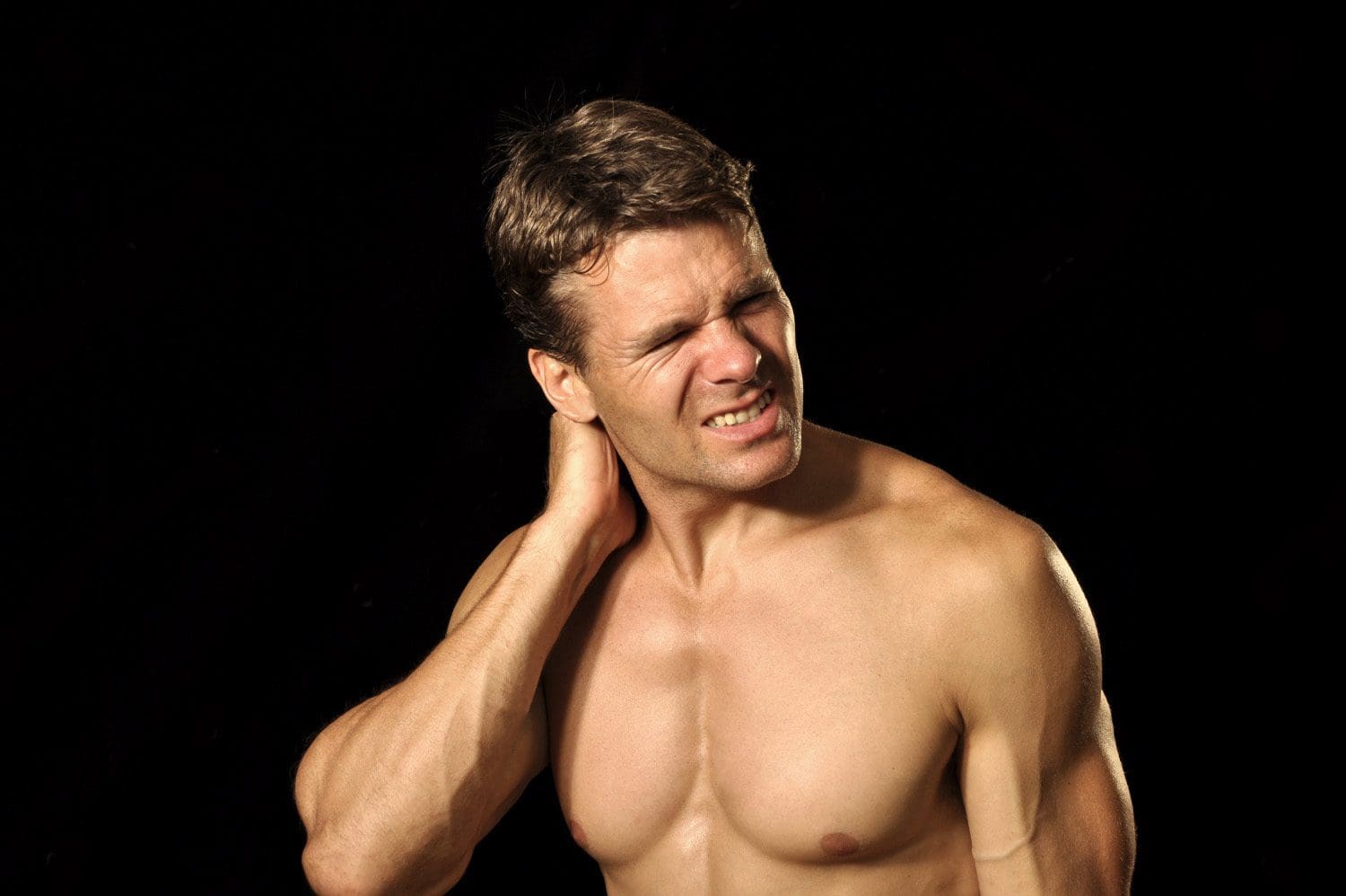 male athlete suffers from acute neck pain
