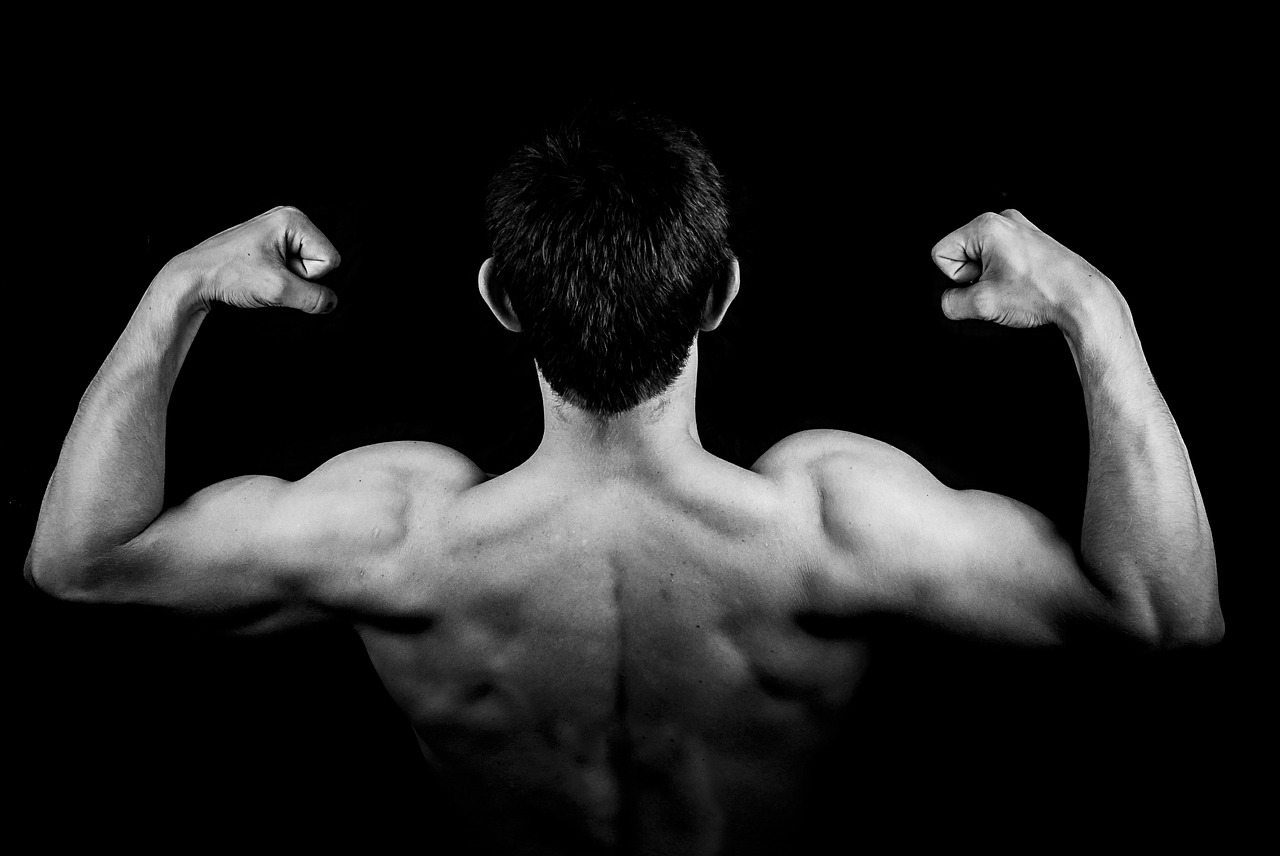 blog picture of man flexing muscles from the back