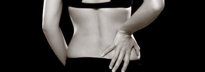 blog picture of woman grabbing her back with sciatic nerve pain
