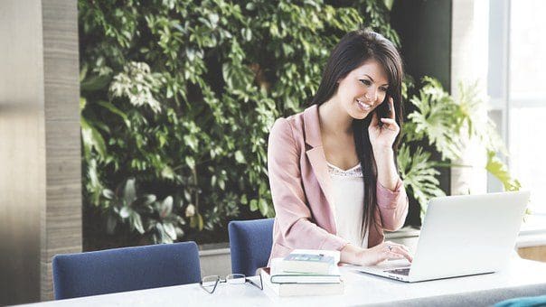 lady at office desk smiling