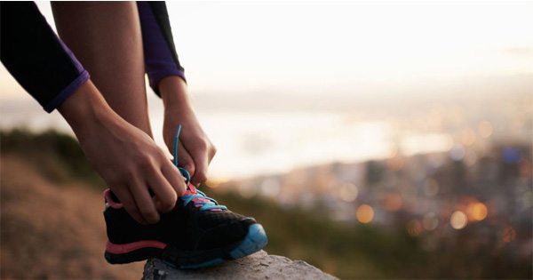 blog picture of woman tying her shoe getting ready to run